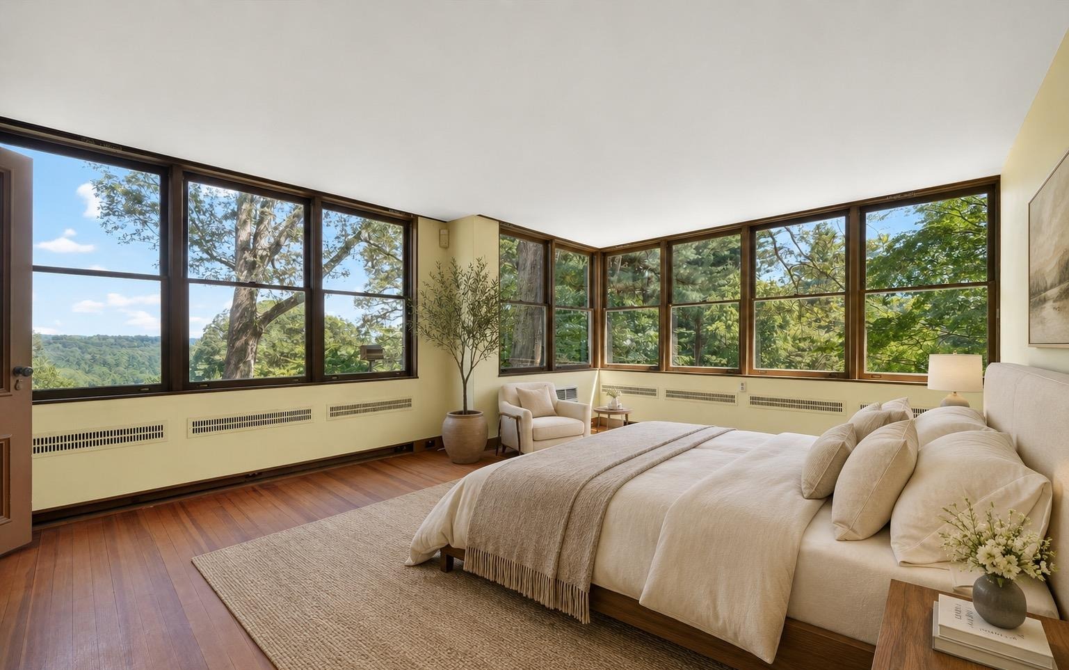 Primary bedroom with wraparound windows overlooking the reservoir