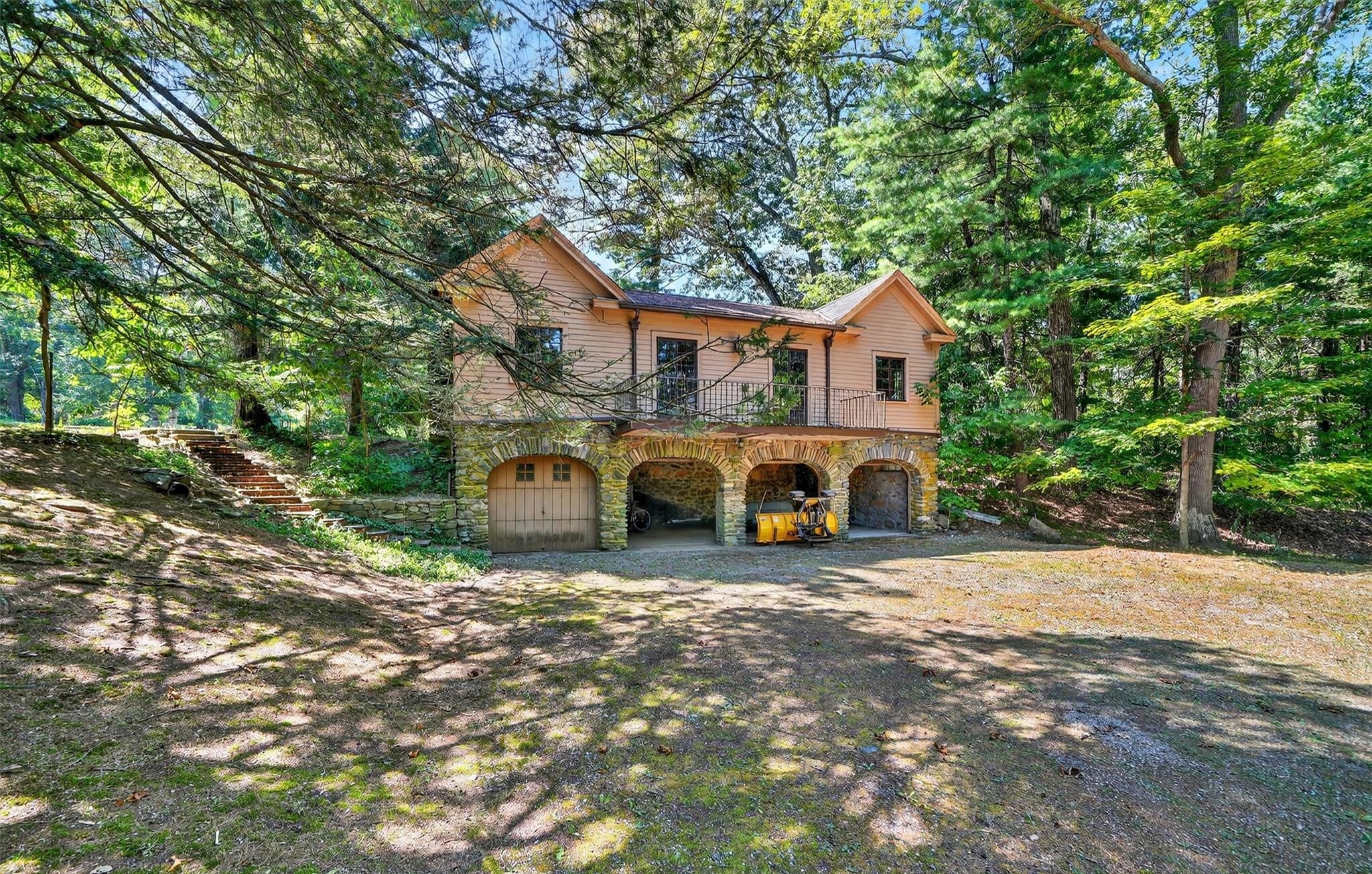 Historic carriage house with stone arches and garage bays