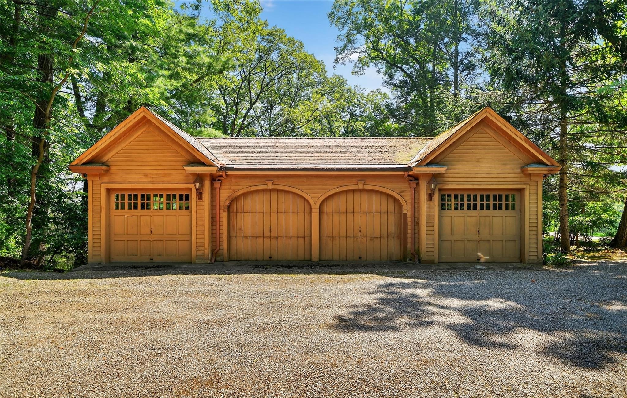 Wood-shingled four-bay garage building